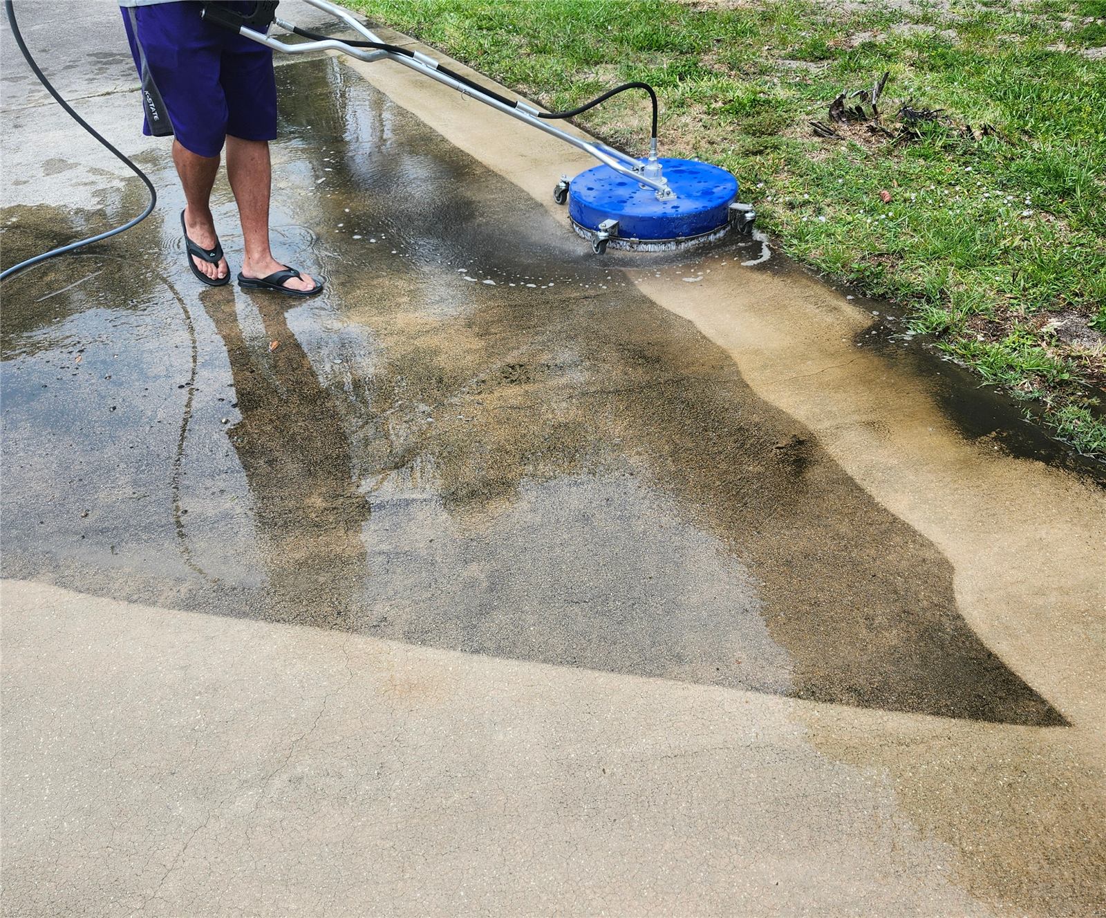 MainSail crew pressure washing a driveway in Vero Beach, FL